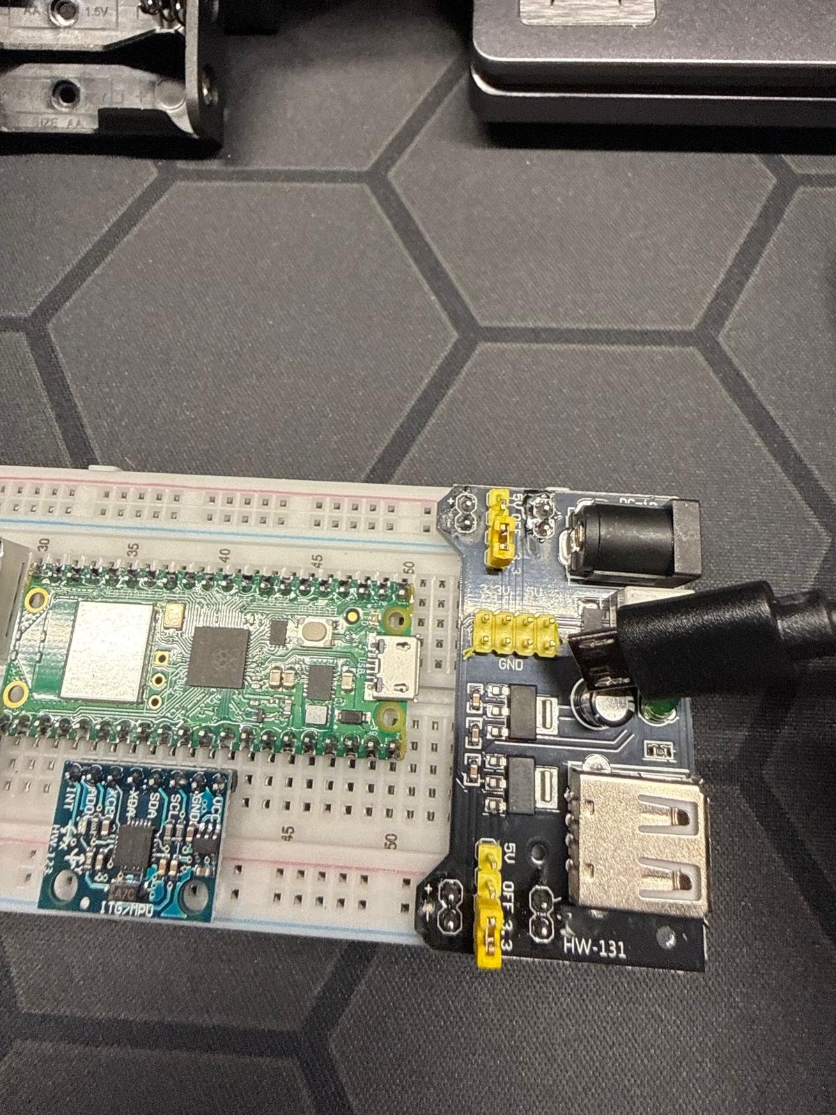 Raspberry Pi Pico W on a breadboard next to an MPU-6050 motion sensor and an HW-131 power module